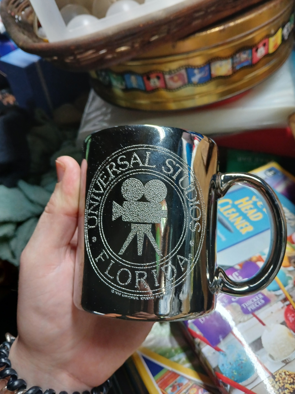 vintage Universal Studios Florida souvenir mug features a reflective, mirror-lik